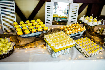 Candy bar. Cupcakes in yellow shades