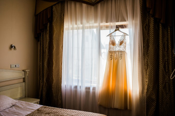 The dress hanging in front of the window