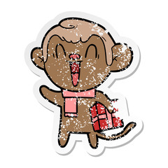 distressed sticker of a cartoon laughing monkey