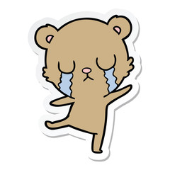 sticker of a crying cartoon bear doing a sad dance