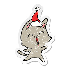 happy distressed sticker cartoon of a cat wearing santa hat