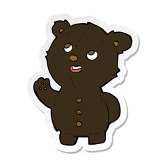 sticker of a cartoon cute black bear cub