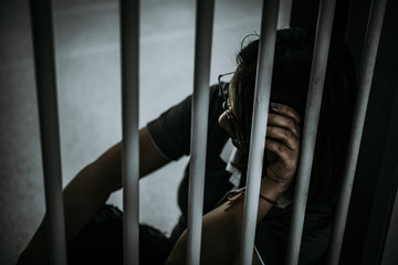 Portrait of woman desperate to catch the iron prison,prisoner concept,thailand people,Hope to be...