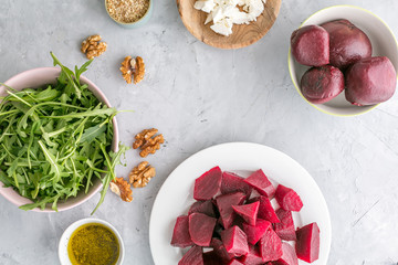 Ingredients ready for preparing beetroot salad with goat cheese and walnuts. top view