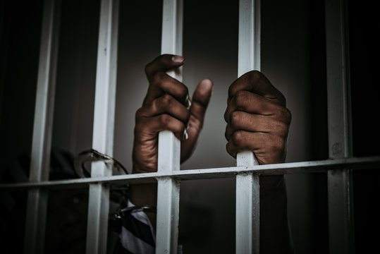 Portrait of Asian men desperate to catch the iron prison,prisoner concept,thailand people,Hope to be free.