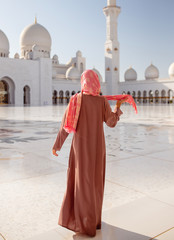 woman like a litte girl playing on the sun of dubai