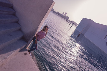 woman like a litte girl playing on the sun of dubai