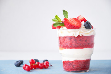 Cake dessert. Trifle red velvet in glass with fresh berries, mint leaves.