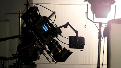 Video camera in film or movie production on tripod and professional gear which shooting in location...