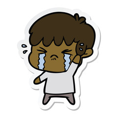sticker of a cartoon boy crying