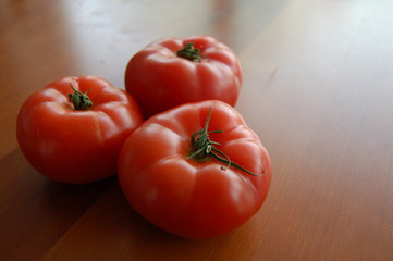 fresh tomatoes on wooden table