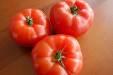fresh tomatoes on wooden table