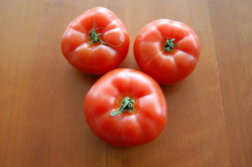 fresh tomatoes on wooden board