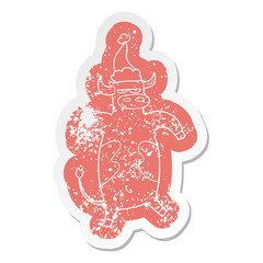 cartoon distressed sticker of a bull wearing santa hat