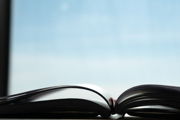 Open notebook for studying on the desk in the morning sun. 