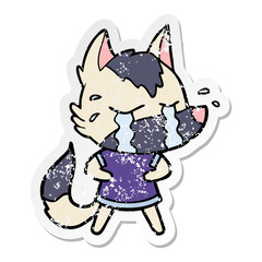 distressed sticker of a cartoon crying wolf