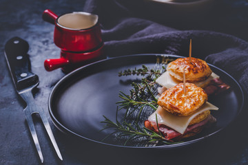 Sandwiches from puff pastry dough with ham and cheese with herbs