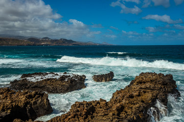 Fototapeta na wymiar Tourism and travel. Windy day on the ocean. Rocky coast. Canary Islands, Gran Canaria, Atlantic Ocean. Tropics