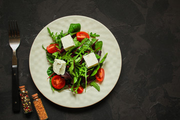 Healthy salad, leaves salad mix in a white plate and cheese (green, juicy snack). food background - Image