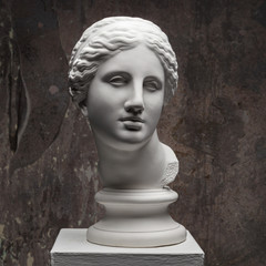 White marble head of young woman. Statue art sculpture of stone face. Ancient beautiful woman...