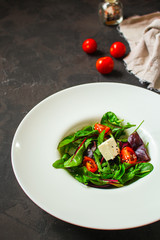 Healthy salad, leaves salad mix in a white plate and cheese (green, juicy snack). food background - Image