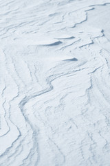 Fresh snow background texture. Winter background with snowflakes and snow mounds. Snow lumps.