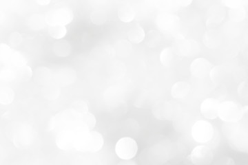 Obraz premium A brilliant white background with circles and ovals. Template for a holiday card with bright and sparkling lights.