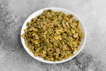 Pumpkin seeds close up. Breakfast, healthy food. It can be used as a background