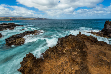 Tourism and travel. Windy day on the ocean. Rocky coast. Canary Islands, Gran Canaria, Atlantic Ocean. Tropics