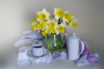 Still life with spring, yellow daffodils in a vase on the table