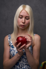 beautiful girl in a fashionable dress with apple