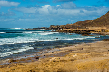 Tourism and travel. Windy day on the ocean. Ruined old fortress. Canary Islands, Las Palmas, Atlantic Ocean. Tropics