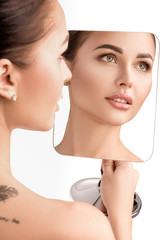 Beautiful girl looks in the mirror. Cosmetology, clean skin