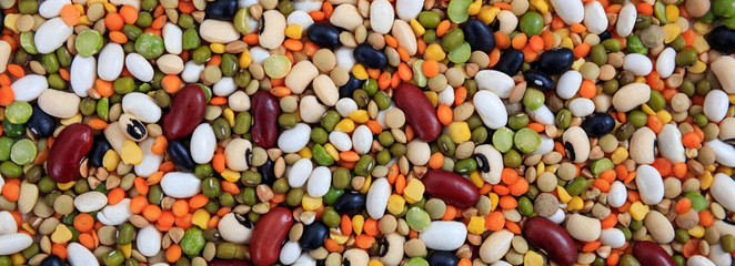 Mixed dry uncooked legumes full background, banner