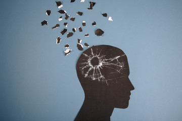 Brain disorder symbol presented by human head made form paper . Creative idea for Alzheimer's disease, dementia, memory loss and mental health concept.
