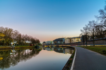 Fototapeta premium Germany, Saarbruecken city reflecting in saar river at dawn