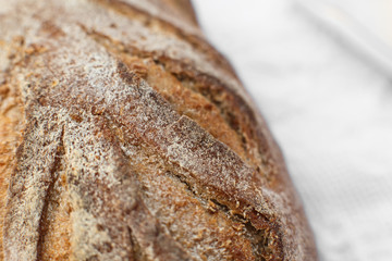 Closeup fresh baked bread on light blurred background