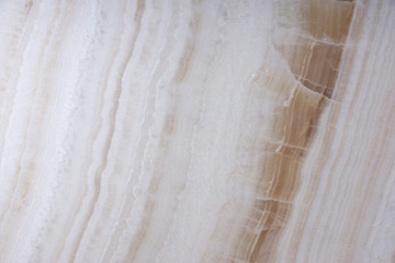 Natural stone of white color with brown veins, called Onyx