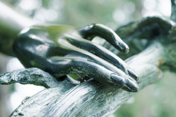 Female hand, element of bronze sculpture, close-up, soft focus, toned