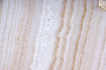 White natural stone with brown stripes called Onyx