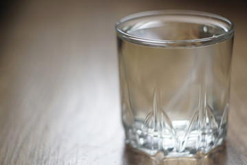 a glass of water on a wooden table