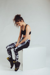 Young fitness woman posing at the studio