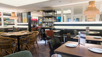 Fototapeta na wymiar Light interior of cozy hall of modern restaurant in fusion style