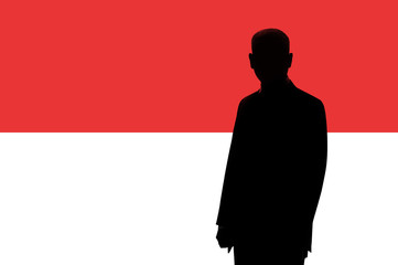 Silhouette of businessman on the background of the Monaco flag. Silhouette of a man, with space for text.