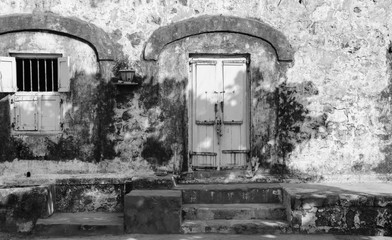 Haunted House Main Wooden Door along Side Window Black and White