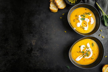 Pumpkin creamy soup served in bowls