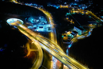 Fototapeta na wymiar Night scene Intersection cross road with vehicle movement aerial view by drone, City transport, Sochi, Russia