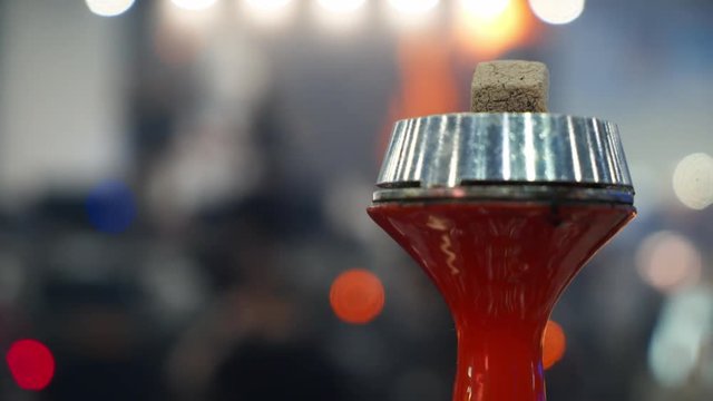 People choosing hookah. Smoking tobacco at exhibition. Shisha bowl at event
