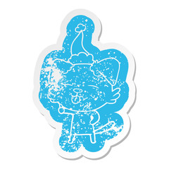 cartoon distressed sticker of a dog sticking out tongue wearing santa hat