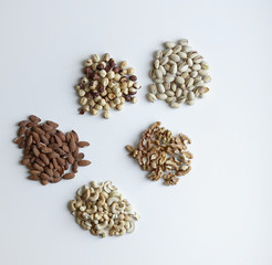 Healthy food. Nuts mix assortment on stone table top view. Collection of different legumes for background image close up nuts, pistachios, almond, cashew nuts, peanut, walnut. image